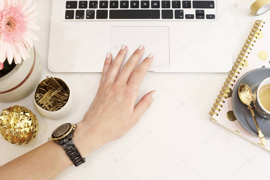 Feminine workplace concept in flat lay style with laptop, coffee