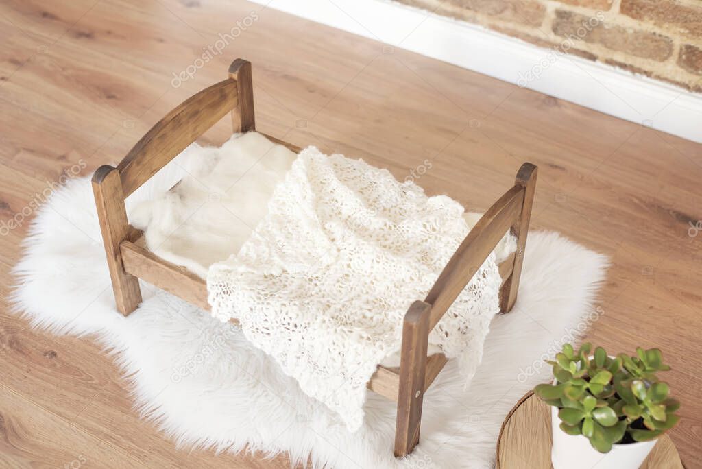 Wood Doll Bed With Crochet Bed Sheet, Succulent Plant Pot. Brick Walll Background.