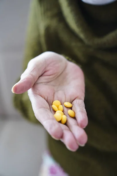 pills in a Senior\'s hands. Painful old age. Caring for the health of the elderly.