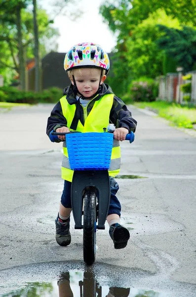 Little boy riding a pushbike with blue basket in a countryside. 스톡 이미지