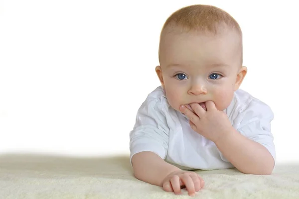 Baby is sucking fingers because of his first teeth — ストック写真