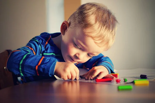 Cute boy is drawing wax pastels. Vintage style. 스톡 사진