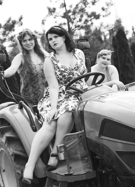 Three young girls plus size on Minitractor. Black and White