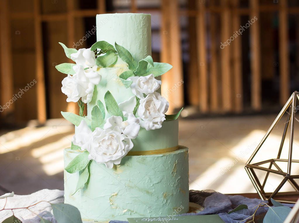 Wedding Cake with flowers on the table. 