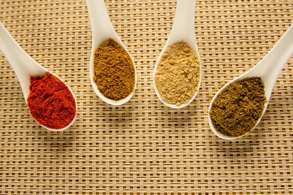 Spices in spoons on the table. — Stock Photo, Image
