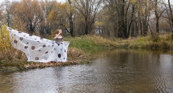 Дама в винтажном белом платье в лесу у озера . — стоковое фото