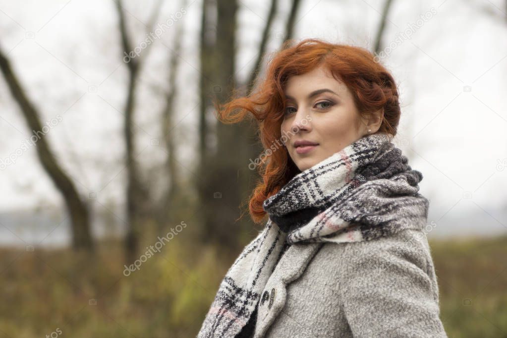 Portrait of beautiful young girl outdoors in the autumn 