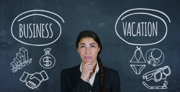 Portrait of a beautiful business girl (student) thinking of choosing a business or vacation, in the background of a black board. Concept ideas university college question choice of profession thinking