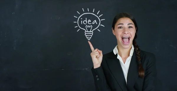 Porträt einer glücklichen schönen Business-Girl (Studentin) hat eine neue Idee und Erfolg gefunden, im Hintergrund einer Tafel. Konzeptideen, Universität, Hochschule, Frage, Berufswahl, Denken — Stockfoto