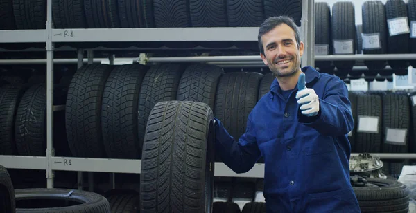 Specialist tire fitting in the car service, checks the tire and rubber tread for safety. Concept: repair of machines, fault diagnosis, repair specialist, technical maintenance and on-board computer. — Stock Photo, Image