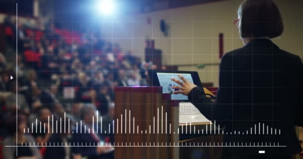 Woman holds a speech to the audience in an futuristic and technology auditorium on a convention of economics and finance their business.concept:world economy,futuristic conference,holograms,technology — Stock Video