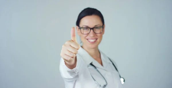 Portrait of a female doctor with white coat and stethoscope smiling looking into camera on white background. Concept: doctor, health care, love of medicine. — Stock Photo, Image