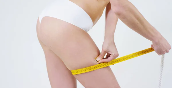 Young girl smears cream her beautiful, perfect body(waist), on a white background. Concept: vegetarian, diet, proper nutrition, spa procedures, fresh, fitness, bio products, body care, perfect skin. — Stock Photo, Image