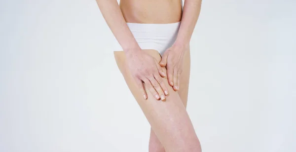 Young girl smears cream her beautiful, perfect body(waist), on a white background. Concept: vegetarian, diet, proper nutrition, spa procedures, fresh, fitness, bio products, body care, perfect skin. — Stock Photo, Image