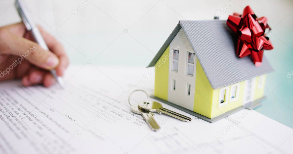 insurance of fire and theft .the hands of an insurer or real estate agent showing a house with floor plan and documents with ensured house keys . concept of home , family, insurance. rent house