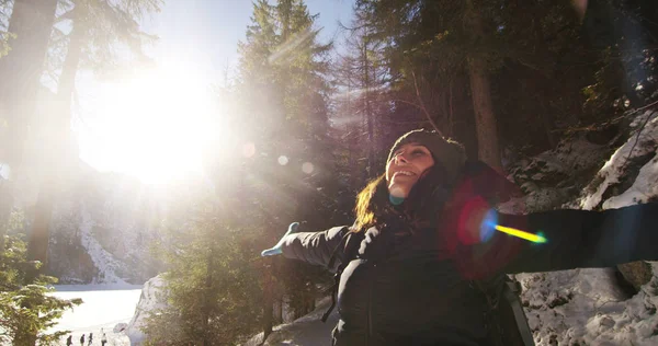 Slowmotion av en flicka promenader genom skogen och i snö, andas ren luft, leenden i naturen av berget, är promenader med vandring ryggsäck. Koncept: avkoppling, vandring, kärlek, renhet, frihet — Stockfoto