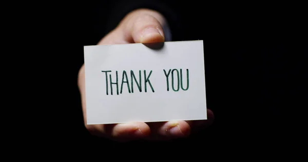 En hand som visar ett kort som säger: "Tack". affärsidé, tack, records webbplats. — Stockfoto