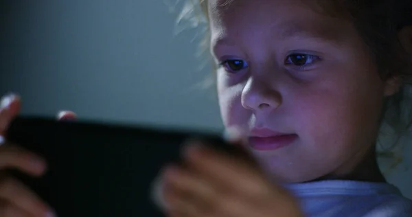 eyes macro of child while using a tablet, smartphone.the future of web technology and video technology concept. connections and vision of the future of children with the web. Internet protection.