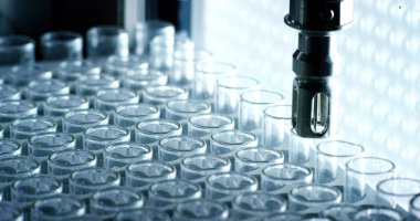 Bir laboratuarda, pipetli bir bilim adamı test tüplerindeki DNA ve molekülleri ayırmak için renkli bir sıvıyı analiz eder. Konsept: araştırma, biyokimya, doğa, ilaç