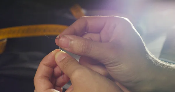 Movimento lento costurar de uma mão de um jovem alfaiate que costurar com uma agulha e linha à mão de acordo com a antiga tradição de costura . — Fotografia de Stock
