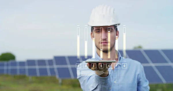 engineer expert in solar energy photovoltaic panels with remote control performs routine actions for system monitoring using clean, renewable energy. concept applied to the remote support technology.