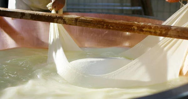 Super slow motion of middle aged cheese maker working on Italian Parmesan cheese / Parmigiano Reggiano process (close up ) — стоковое фото