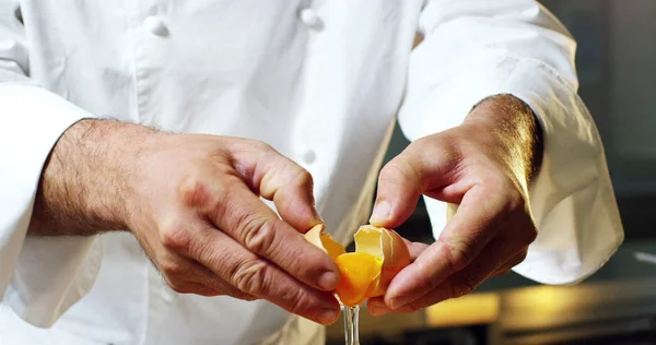 An Italian chef breaks and slams fresh egg yolk and bio with a fork, to mix and to use it as an ingredient to an Italian recipe.Concept of Italian food and gourmet , healthy diet and bio.