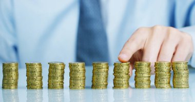 Bir işadamı bir takım elbise ve kravat onu daha önce birçok altın sikke yığını var. İşadamı sayar ve parayı dikkatli izle. Konsept: yatırım bankaları, borsa, emeklilik ve özel kredi.