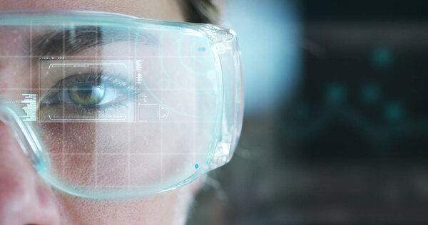 A woman watches with a futuristic look with glasses. augmented reality in holography.