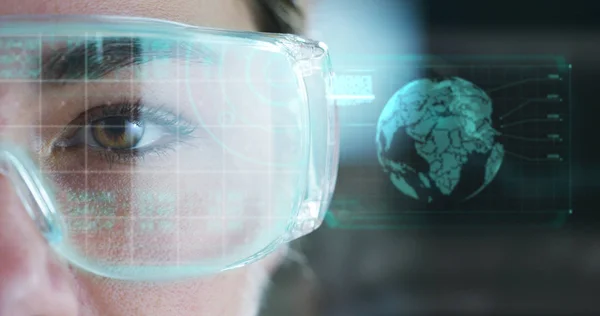 A woman watches with a futuristic look with glasses. augmented reality in holography. — Stock Photo, Image