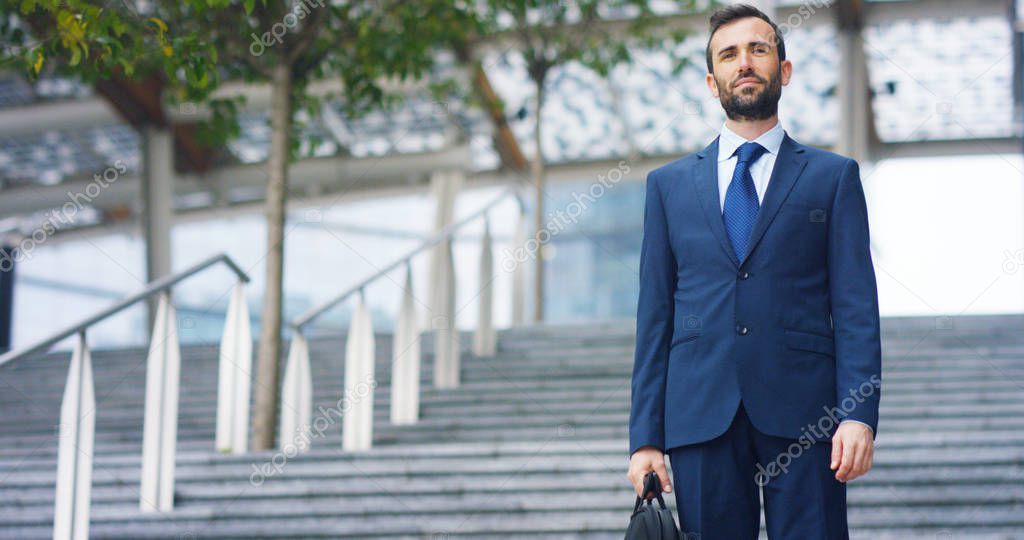 A man in a suit, looks in camera and smiles proud and sure of himself. Concept of politics, business, finance, banking, insurance and testimonials for political campaign.