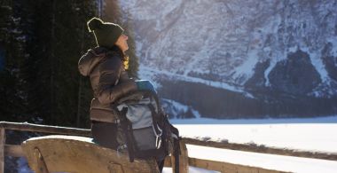 slow motion of A girl walks through the woods and in the snow, breathe pure air, smiles in the nature of the mountain, is walking with hiking backpack.Concept:relaxation, hiking, love, purity, freedom clipart