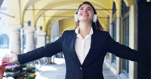 Una hermosa mujer de carrera escucha música y bailes. La empresaria jugando y divirtiéndose con la música — Foto de Stock