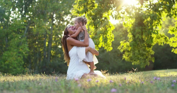 Ecology, young mother with her adorable two year old girl playing outdoors with love. concept of family love of nature. happy children with the love of parents. concept of green and sustainability. — Stock Photo, Image