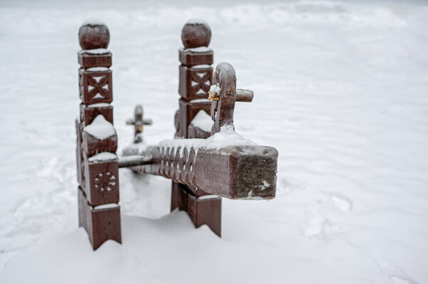 Playground bench under the snow