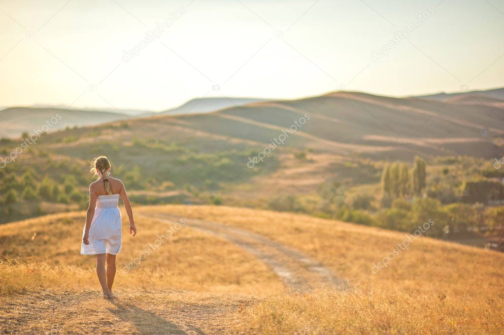 Girl is walking over the mountains path