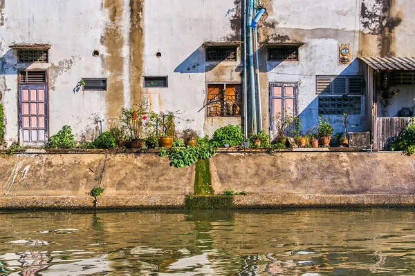 Thai houses along Khlong Rob Krung Canal in Bangkok, Thailand