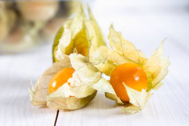 Egzotik meyveler physalis Beyaz ahşap bir masa üzerinde.