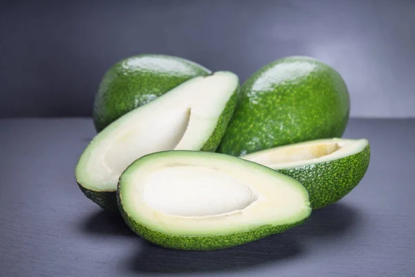 Avocado auf grauem Hintergrund — Stockfoto