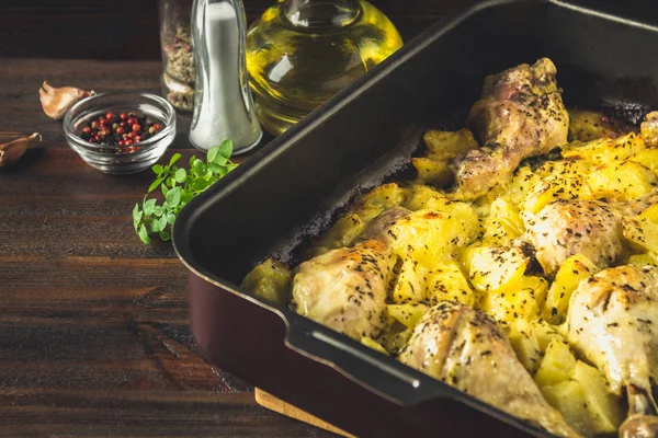 Kimyon ve sarımsak ile patates ile kavrulmuş tavuk budu.