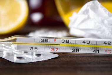 Cam Merkür termometre 37.5 ilaçlar, limon, çay, halk ilaçları, tablet, sprey arka planı yüksek bir sıcaklık. Hastalığı tanısı. Tedavi.