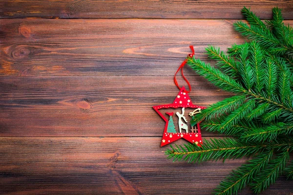 Boże Narodzenie drzewo gałąź z zabawką na podłoże drewniane — Zdjęcie stockowe