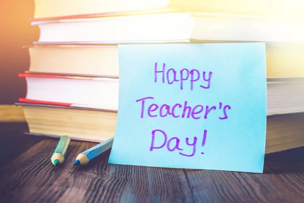 Concept of Teacher\'s Day. Objects on a chalkboard background. Bo