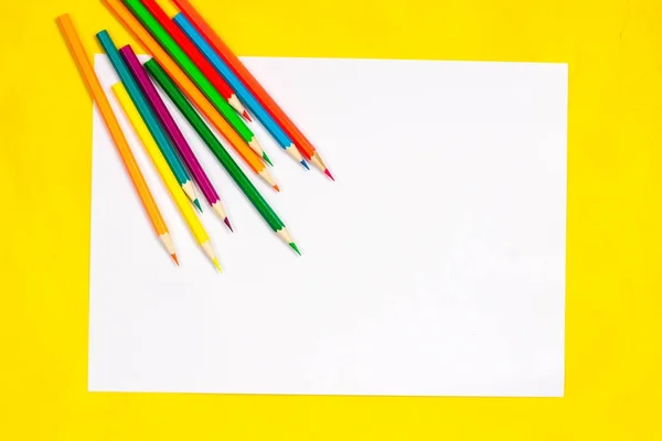 School supplies and white sheet on a bright yellow background, ready for your design — Stock Photo, Image