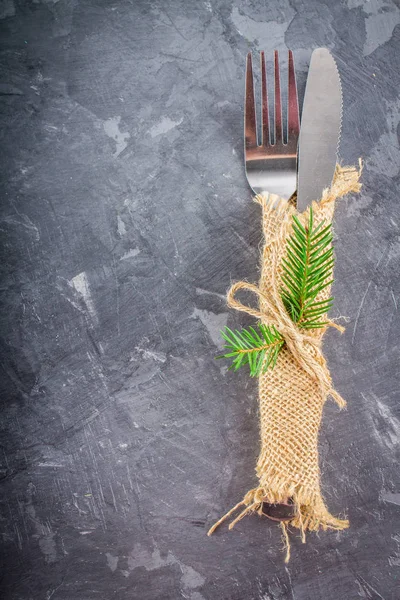 Fork with a knife in the sacking on a gray background — Stock Photo, Image