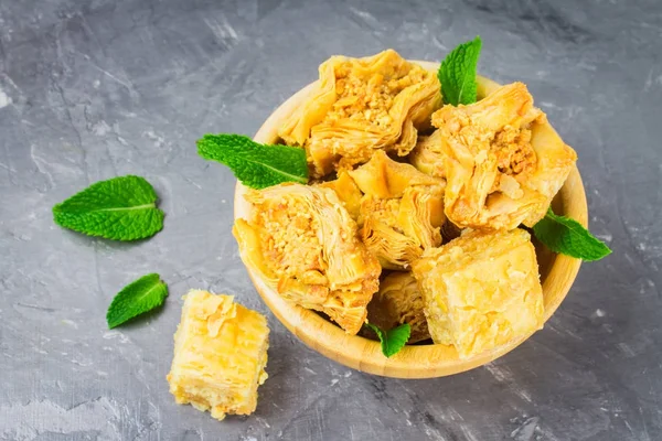 baklava turkish traditional delight on a dark wood background. toning.