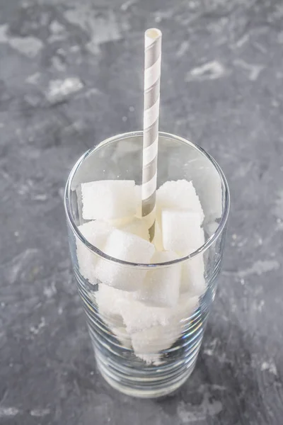 Sklo se kostky cukru je nezdravá strava. Obsah cukru v sladkou limonádu. — Stock fotografie