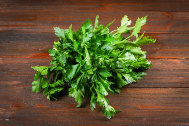 Bir demet ahşap bir masa üzerinde yeşil maydanoz.