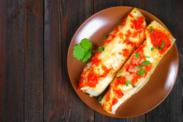 Enchiladas de pollo caseras en plato sobre mesa de madera. Vista superior . —  Fotos de Stock