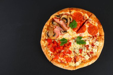 Sucuklu, petrol, domates ve peynirli pizza. Bir pizza dört tadı. siyah yazı tahtası.